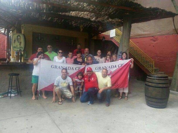 Integrantes de la peña de Deifontes, posando con dos banderas granadinistas.