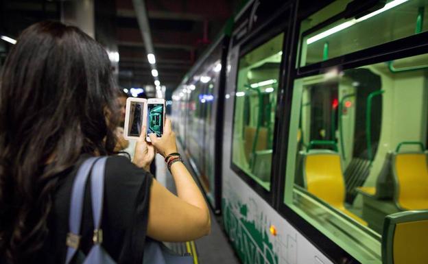 Una chica toma una imagen del metro en la parada de Recogidas. /FERMÍN RODRÍGUEZ