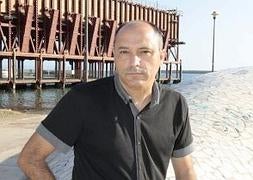 Pedro Asensio posa con su libro en el Puerto de Almería. :: CHEMA ARTERO/
